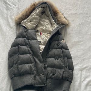 Gray Moncler puffer vest with fur hood.